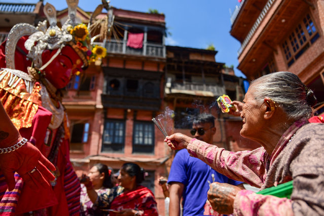 Newar Buddhist devotees worship Dipankara Buddha during the Panchadaan festival in Bhaktapur, Nepal on August 21, 2025. Known as the festival of five summer gifts, Panchadaan is a sacred ritual in which devotees honour Dipankara Buddha and offer five traditional alms in monastic courtyards and community squares. (Photo by Safal Prakash Shrestha/ZUMA Press Wire/Rex Features/Shutterstock)