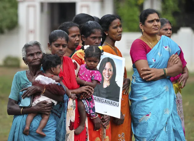 Indian village women, one holding a placard featuring U.S. Vice President-elect Kamala Harris during celebrations for her victory, in Painganadu a neighboring village of Thulasendrapuram, the hometown of Harris' maternal grandfather, south of Chennai, Tamil Nadu state, India, Sunday, November 8, 2020. Waking up to the news of Kamala Harris' election as Joe Biden's running mate, overjoyed people in her Indian grandfather's hometown are setting off firecrackers, carrying her placards and offering prayers. (Photo by Aijaz Rahi/AP Photo)