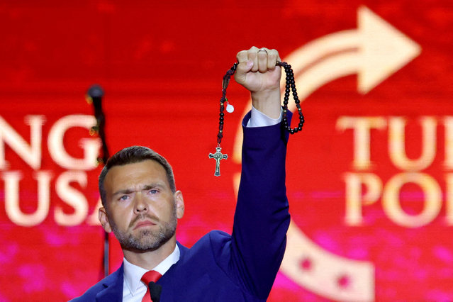 Jack Posobiec holds up a rosary as he speaks during a memorial service for slain conservative commentator Charlie Kirk at State Farm Stadium, Arizona, U.S., September 21, 2025. (Photo by Carlos Barria/Reuters)