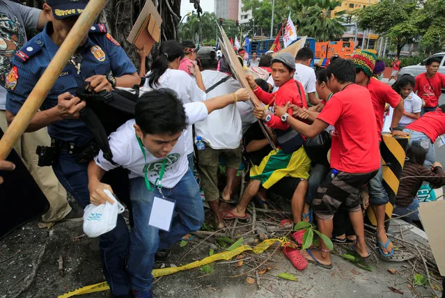 A police officer tries to detain a demonstrator after a violent dispersal of various activist and Indigenous People's (IP) groups protesting against the continuing presence of U.S. troops in the Philippines in front of the U.S. Embassy in metro Manila, Philippines October 19, 2016. (Photo by Romeo Ranoco/Reuters)
