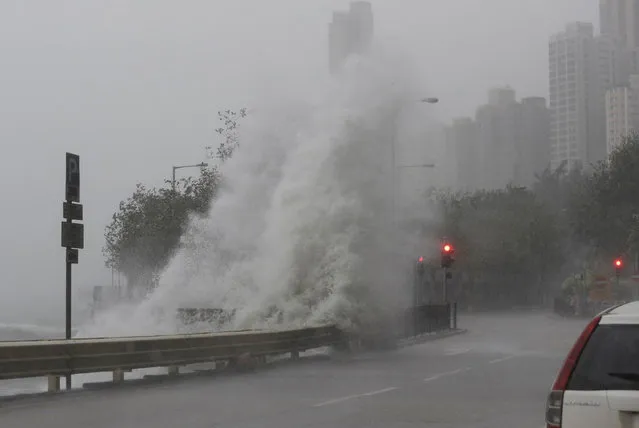 Waves crash on waterfront caused by Typhoon Haima in Hong Kong, Friday, October 21, 2016. (Photo by Kin Cheung/AP Photo)