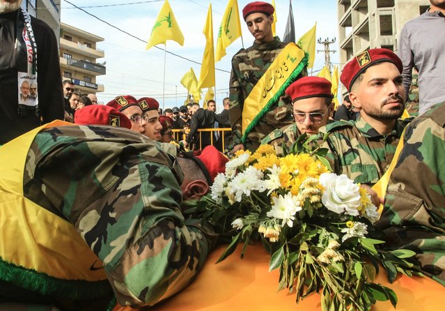 Members of Lebanon's Shiite militant group Hezbollah mourn over the coffins of comrades killed in recent Israeli attacks during their funeral in the southern city of Nabatiyeh on November 2, 2025. Hundreds of people gathered in south Lebanon's Nabatiyeh on November 2, 2025 to mourn five Hezbollah members killed in recent Israeli attacks, an AFP correspondent said, as Israel warned of intensifying attacks against the Iran-backed group. On November 1, an Israeli strike killed four people in Kfar Rumman, Nabatiyeh district, the Lebanese health ministry and the Israeli military said. (Photo by Mahmoud Zayyat/AFP Photo)