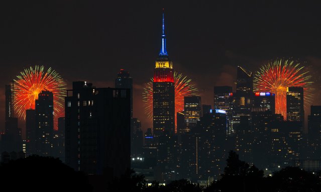 The Macy's 4th Of July fireworks show lights up the night sky as a backdrop to the Empire State Building on July 4, 2024 in New York City. The annual spectacle, lighting up the city since 1976, this time was launched from barges in the Hudson River, the first time in more than a decade not done from the East River. (Photo by Adam Gray/Getty Images)