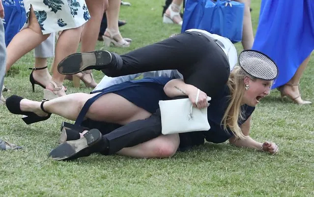Racegoers trip over each other following 2016 Melbourne Cup Day at Flemington Racecourse on November 1, 2016 in Melbourne, Australia. (Photo by Scott Barbour/Getty Images)