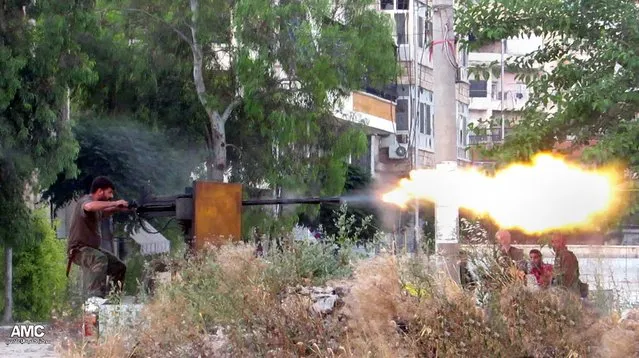 A Syrian rebel fighter fired toward government forces in Aleppo, Syria, on June 20, 2013. The Associated Press has authenticated the image, which was provided by the Aleppo Media Center AMC. (Photo by Aleppo Media Center AMC/Associated Press)