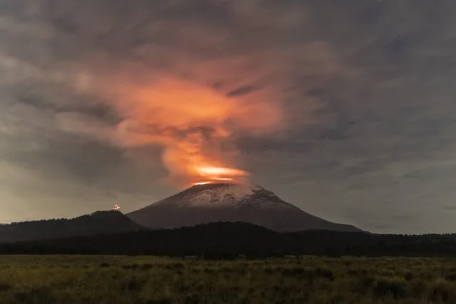 Popocatepetl volcano spews incandescent material as seen from Paso de Cortés on May 23, 2023 in Amecameca, Mexico. The second highest volcano in the country increased its activity while Mexican authorities raised the alert to yellow phase 3. Popocatepetl volcano caused the fall of ashes in different municipalities in Puebla, Estado de Mexico and Mexico City. Mexican army has spread forces as a preventive measure while the 3 levels of government are in coordination to observe the activity of the volcano and the situation in the surroundings. (Photo by Cristopher Rogel Blanquet/Getty Images)