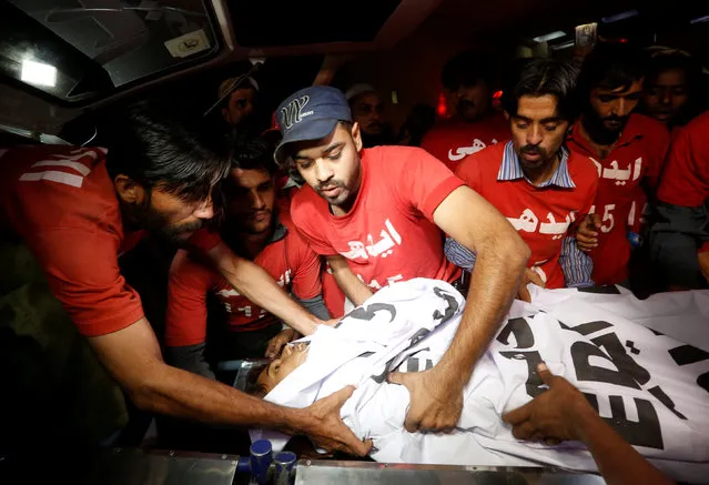 Rescue workers move an injured person from an ambulance after an explosion in at the Shah Noorani Shrine in Baluchistan, outside a hospital in Karachi, Pakistan, November 12, 2016. (Photo by Akhtar Soomro/Reuters)