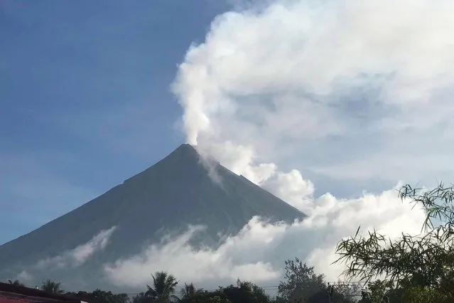 This handout photo made available by Kristin Moral shows the Mount Mayon spewing white smoke as seen from Camalig on June 8, 2023. Hundreds of families living around Mount Mayon in central Albay province are expected to be moved to safer areas after the Philippine Institute of Volcanology and Seismology raised a “hazardous eruption” alarm. (Photo by Kristin Moral/Handout via AFP Photo)