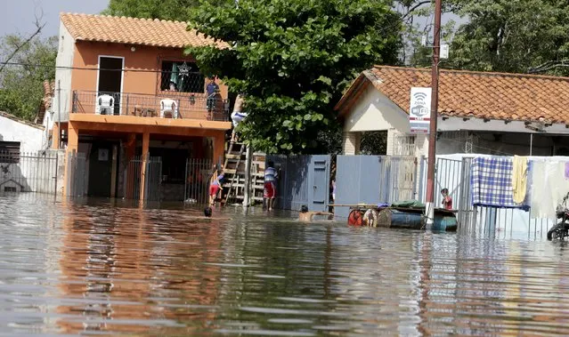 Houses are partially submerged in flood waters in Asuncion, December 20, 2015. (Photo by Jorge Adorno/Reuters)