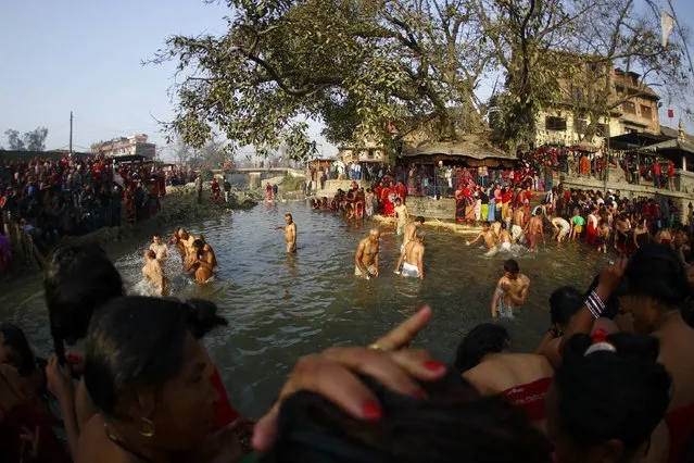Devotees offer prayer by taking a bath in the Hanumante River, on the final day of the month-long Swasthani festival, at Bhaktapur, near Kathmandu, February 3, 2015. (Photo by Navesh Chitrakar/Reuters)