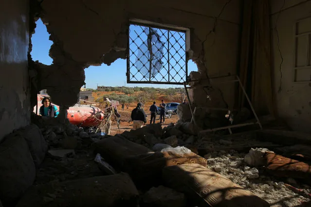 People inspect the damage at a site hit by an airstrike in Kafr Jales village, north of Idlib City, Syria November 17, 2016. (Photo by Ammar Abdullah/Reuters)