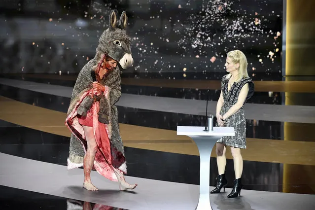 French actress Corinne Masiero (L) delivers a speech wearing a “Peau d'Ane” costume next to French actress and Master of Ceremony Marina Fois during the 46th Cesar Award ceremony on Friday, March 12, 2021 in Paris. (Photo by Bertrand Guay/Pool via AP Photo)