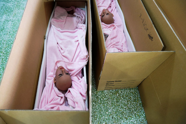 s*x doll heads are seen in boxes about to be sealed and shipped off to customers at the WMDOLL factory in Zhongshan, Guangdong Province, China, July 11, 2018. The factory produces around 2,000 dolls a month, including dozens of different shapes of body and over 260 different faces. (Photo by Aly Song/Reuters)