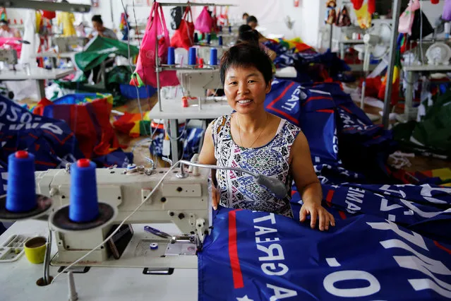 A worker poses for pictures as she makes flags for U.S. President Donald Trump's “Keep America Great!” 2020 re-election campaign at Jiahao flag factory in Fuyang, Anhui province, China July 24, 2018. (Photo by Aly Song/Reuters)