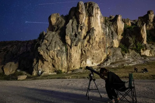 Visitors watch the sky during the Perseid meteor shower over the historical Phrygian Valley near Ihsaniye, in the Afyonkarahisar district on August 12, 2023. (Photo by Yasin Akgul/AFP Photo)
