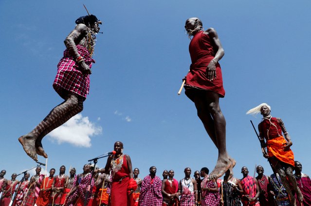 Members of the indigenous Maasai community sing and jump at the inaugural Maa Cultural Week dubbed The Maa-Festival aimed to promote peace, tourism, and cultural exchange as the wildebeests (Connochaetes taurinus) make their annual cross border migration at the Sekenani village, in the Maasai Mara National Reserve, in Narok County, Kenya on August 22, 2023. (Photo by Thomas Mukoya/Reuters)