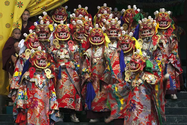 Tibetan Buddhist monks perform a dance called 'cham' wearing traditional masks, at the Sherabling monastery, about 70 kilometers (40 miles) south of Dharmsala, India, Friday, December 9, 2016. These traditional dances are performed to celebrate the life of the 8th century Indian seer Padmasambhava, who is revered by Tibetans for his role in spreading Buddhism in Tibet. (Photo by Ashwini Bhatia/AP Photo)
