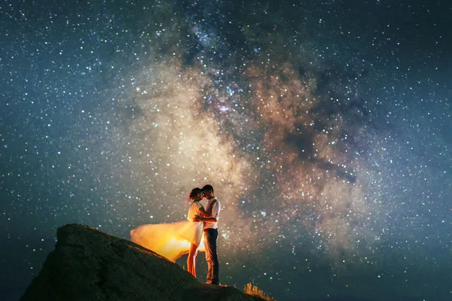 Stunning photos show couples silhouetted against night sky. (Photo by Andrei Sheliakin/Caters News Agency)