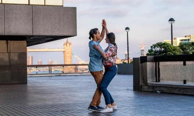 Luis Alberto and Marta practice their salsa dancing on an office walk way near London Bridge on June 1, 2021. (Photo by Jill Mead/The Guardian)