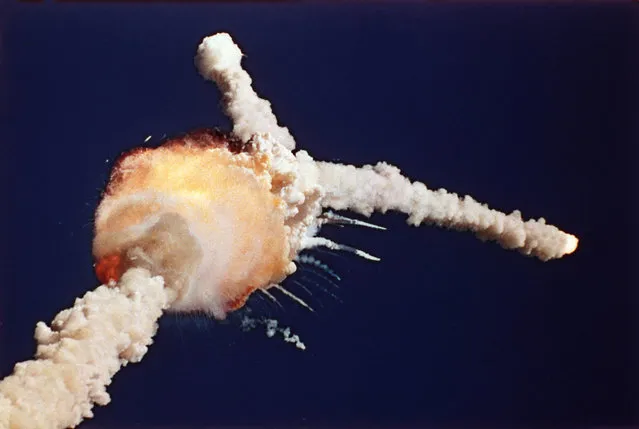 The space shuttle Challenger explodes shortly after lifting off from Kennedy Space Center Tuesday, January 28, 1986. All seven crew members died in the explosion, which was blamed on faulty o-rings in the shuttle's booster rockets. The Challenger's crew was honored with burials at Arlington National Cemetery. (Photo by Bruce Weaver/AP Photo)
