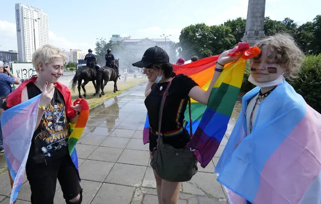 People walk towards the starting point of the Equality Parade, an LGBT pride parade, in Warsaw, Poland, Saturday, June 19, 2021. (Photo by Czarek Sokolowski/AP Photo)