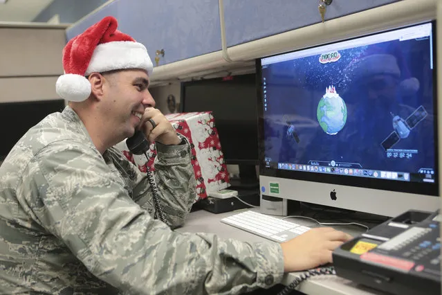 Maj. Jared Scott, makes sure NORAD's Santa tracker is working correctly at Tyndall Air Force Base on Friday, December 23, 2016 in Panama City, Fla. (Photo by Heather Howard/News Herald via AP Photo)
