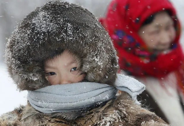 In this photo taken on Sunday, March 15, 2015, a Nenets boy attends the Reindeer Herder's Day holiday in the city of Nadym, in Yamal-Nenets Region, 2500 kilometers (about 1553 miles) northeast of Moscow, Russia. (Photo by Dmitry Lovetsky/AP Photo)