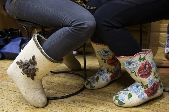 In this photo taken on Thursday, November 15, 2018, women wear designer valenki, traditional Russian footwear, ahead of a fashion show in Moscow, Russia. As freezing temperatures are setting in, Russians are rediscovering the old winter staple: traditional felt boots called valenki. Valenki are traditional winter footwear in Russia, prized for their ability to endure frosty conditions and a dry winter, which is typical for most of the country. (Photo by Alexander Zemlianichenko/AP Photo)