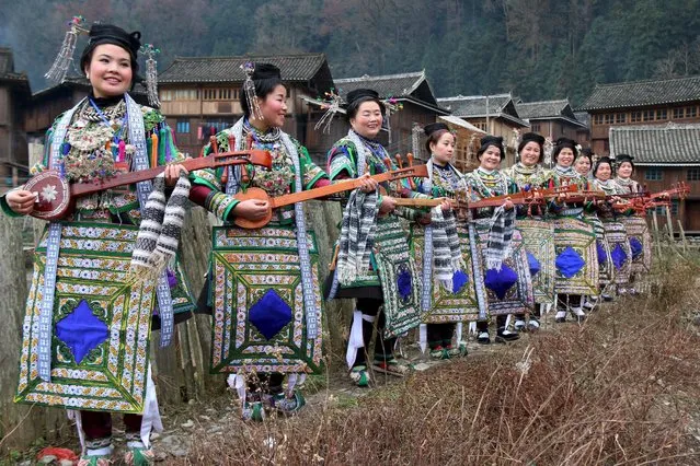 Ethnic Dong women wearing traditional costumes, hold "pipas", a traditional instrument, as they pose for pictures during a rehearsal ahead of the Chinese New Year of the Monkey, which starts on February 8, in Liping county, Guizhou province, China January 28, 2016. (Photo by Reuters/Stringer)
