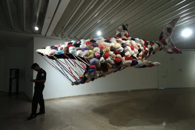 A security guard stands near an art work titled “Shark Bra” during the “Young Malaysian Artist New Objection” exhibition at a gallery in Kuala Lumpur November 12, 2013. The art work took two months and a total number of 300 bras to complete, according to its artist Louis Low. (Photo by Samsul Said/Reuters)