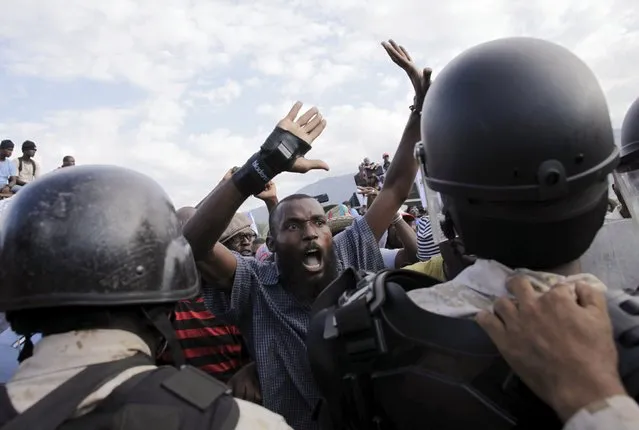 A protester argues with National Police officers at a police cordon during a demonstration called up by opposition groups in Port-au-Prince, Haiti, February 4, 2016. (Photo by Andres Martinez Casares/Reuters)