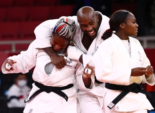 France's Teddy Riner (C) congratulates France's Romane Dicko after she won the decisive point of the judo mixed team's semifinal B bout against Netherlands during the Tokyo 2020 Olympic Games at the Nippon Budokan in Tokyo on July 31 2021. (Photo by Sergio Perez/Reuters)