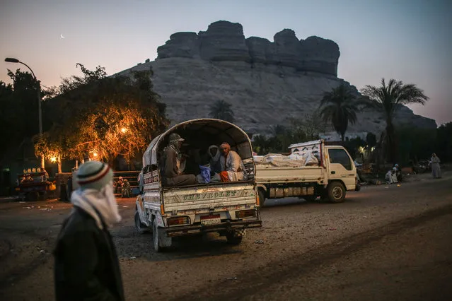 In this Wednesday, March 18, 2015 photo, quarry workers are transported in pickup trucks after dawn from Shurafa village, Minya, southern Egypt. Around 45,000 people, including children, work in an estimated 1,500 quarries, digging out stones that later will be used in construction or powdered to be used by pharmaceutical and ceramic companies. (Photo by Mosa'ab Elshamy/AP Photo)