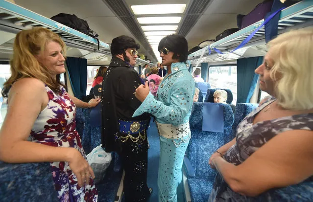 Elvis fans board a train to take them to The Parkes Elvis Festival from Sydney on January 12, 2017. The Parkes Elvis Festival is an annual event celebrating the music and life of Elvis Presley in the New South Wales town of Parkes. (Photo by Peter Parks/AFP Photo)