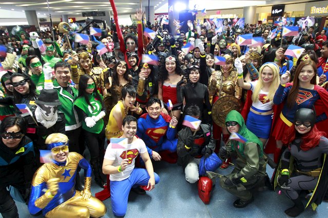 Participants wearing superhero costumes wave Philippine flags during the World DC Comics Super Heroes gathering in Manila April 18, 2015. (Photo by Romeo Ranoco/Reuters)