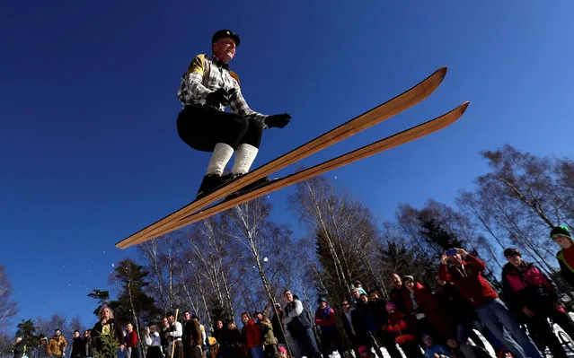 A participant jumps on vintage skis during a traditional historical ski race in the northern Bohemian town of Smrzovka, Czech Republic, February 16, 2019. (Photo by David W. Cerny/Reuters)