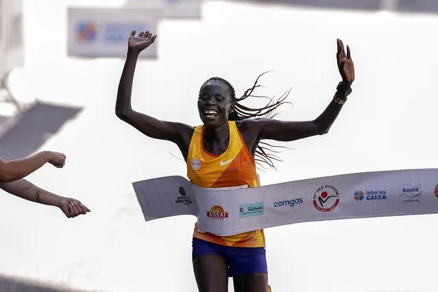 Kenya's Catherine Reline crosses the finish line to win the Sao Silvestre women's road race in Sao Paulo, Brazil, December 31, 2023. The 15-kilometer race is held annually on New Year's Eve. (Photo by Ettore Chiereguini/AP Photo)