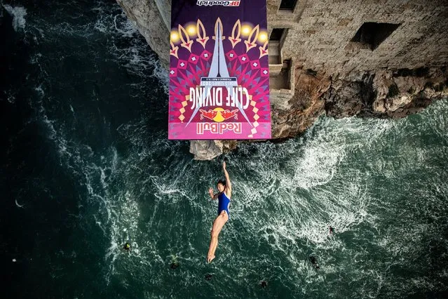 In this handout image provided by Red Bull, Meili Carpenter of the United States dives from the 21 metre platform during the final competition day of the fifth stop of the Red Bull Cliff Diving World Series on September 22, 2021 at Polignano a Mare, Italy. (Photo by Dean Treml/Red Bull via Getty Images)