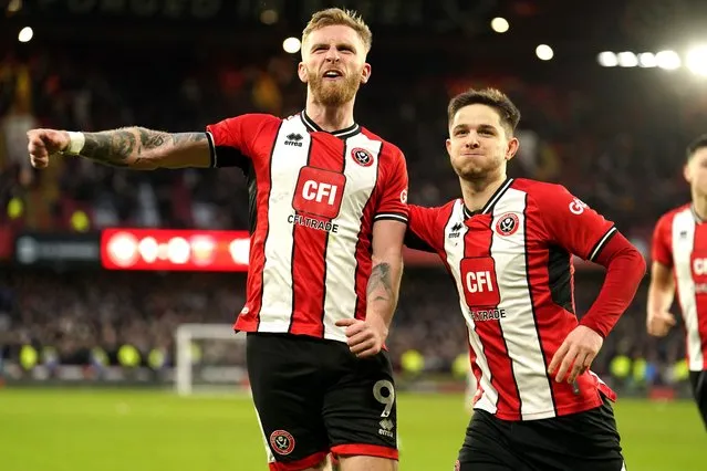 Sheffield United's Oli McBurnie (left) celebrates scoring their side's second goal of the game from a penalty kick during the Premier League match at Bramall Lane, Sheffield, UK on Sunday, January 21, 2024. (Photo by Mike Egerton/PA Images via Getty Images)