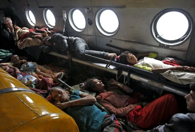 Victims of Saturday's earthquake lie inside an Indian Air Force helicopter as they are evacuated from Trishuli Bazar to the airport in Kathmandu, Nepal, April 27, 2015. (Photo by Jitendra Prakash/Reuters)