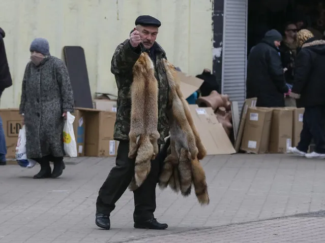 A man gestures as he sells fox furs near a subway station in Kiev, Ukraine, March 2, 2016. (Photo by Gleb Garanich/Reuters)