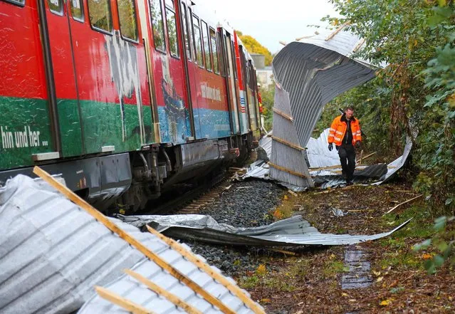 A regional train is pictured after it had to make an emergency stop due to corrugated metal panels from a nearby roof amid strong winds, in Neumuenster, northern Germany, October 21, 2021. (Photo by Thomas Nyfeler/Reuters)
