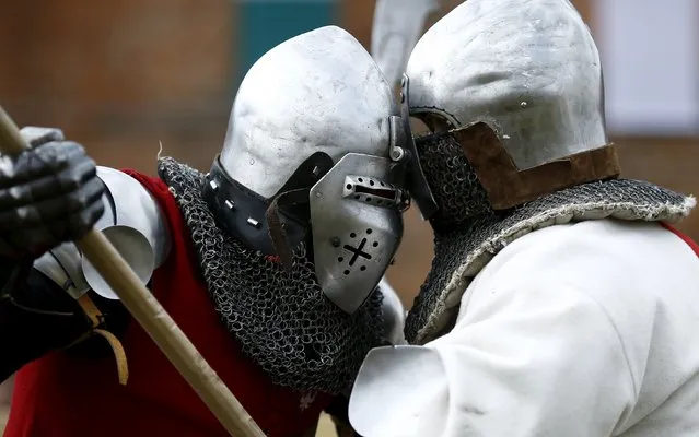 A fighter from Poland (L) competes with English counterpart during their pole arm duel at the Medieval Combat World Championship at Malbork Castle, northern Poland, April 30, 2015. (Photo by Kacper Pempel/Reuters)