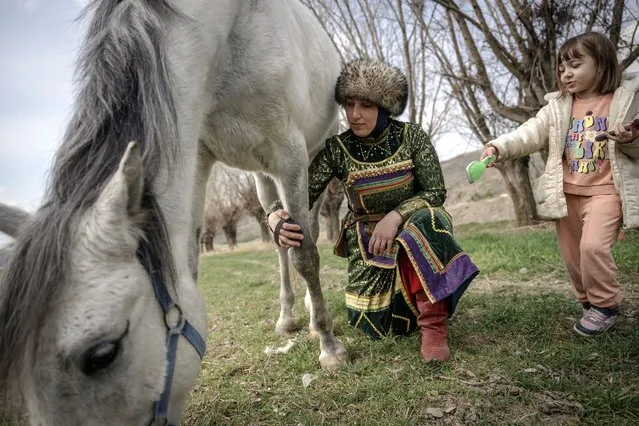 Sevilay Cakir, an English teacher in Ankara's Pursaklar district, who started traditional horse archery, is viewed with her 5 year-old daughter Asya, in Ankara, Turkiye on March 03, 2024. Sevilay Cakir, who started traditional horse archery about 10 years ago with the support of her husband, broke the Turkish record for women by scoring 40.75 points on the table3 course in the races in Aksehir last year. Cakir, mother of 2 children, wants to be one of the women representing her country abroad by entering the top 15 in Turkiye with her horse Akduman. (Photo by Ozge Elif Kizil/Anadolu via Getty Images)