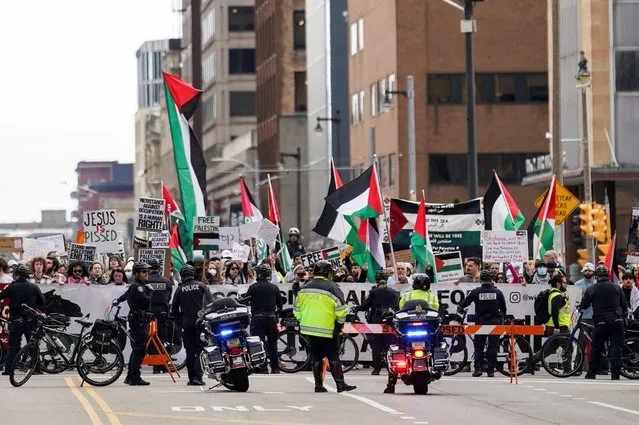Police keep back demonstrators calling for a ceasefire in Gaza, amid the ongoing conflict between Israel and the Palestinian Islamist group Hamas, near the campaign headquarters of U.S. President Joe Biden for the state of Wisconsin, in Milwaukee on March 13, 2024. (Photo by Kevin Lamarque/Reuters)