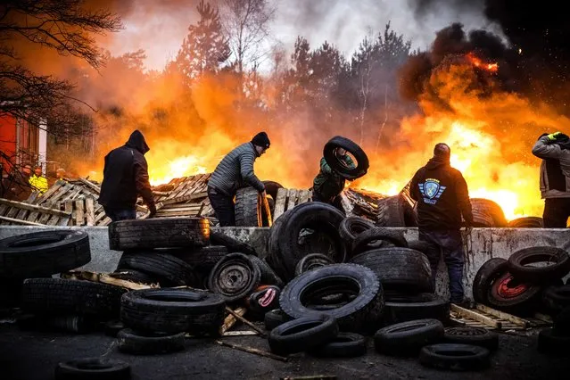 Dutch and Belgian farmers burn tires and wood as they block the border crossing between The Netherlands and Belgium, in Arendonk, Netherlands, 02 February 2024. The farmers demonstrate against agricultural rules that they believe are too strict, and unfair competition within European borders. (Photo by Rob Engelaar/EPA)