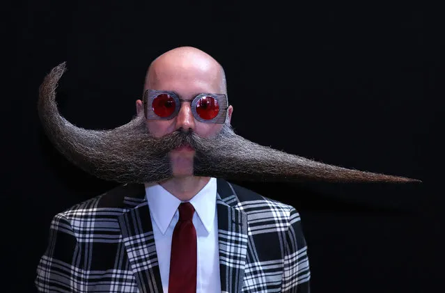 A participant of the international World Beard and Moustache Championships poses before taking part in one of the 17 categories of beard and moustache styles competing in Antwerp, Belgium May 18, 2019. (Photo by Yves Herman/Reuters)