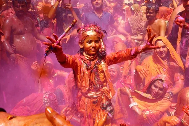 A Hindu devotee dances during the Huranga, a game played between men and women a day after Holi, at Dauji temple near the northern city of Mathura, India on March 26, 2024. (Photo by Sharafat Ali/Reuters)