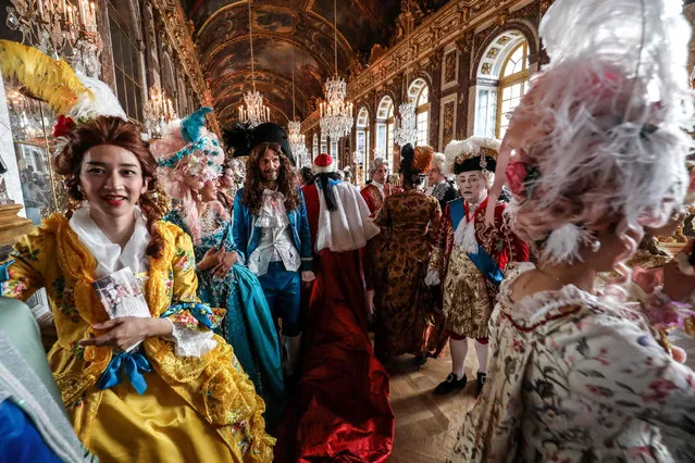 People dressed in period costumes take part in the “Fetes Galantes” fancy dress evening at the “galerie des glaces” in the Chateau de Versailles, France on May 27, 2019. (Photo by Ludovic Marin/AFP Photo)