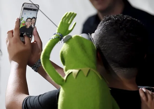 Actor Rico Rodriguez and Raini Rodriguez pose for a selfie photo with Kermit the Frog during We Day California in Inglewood, California, April 7, 2016. (Photo by Danny Moloshok/Reuters)